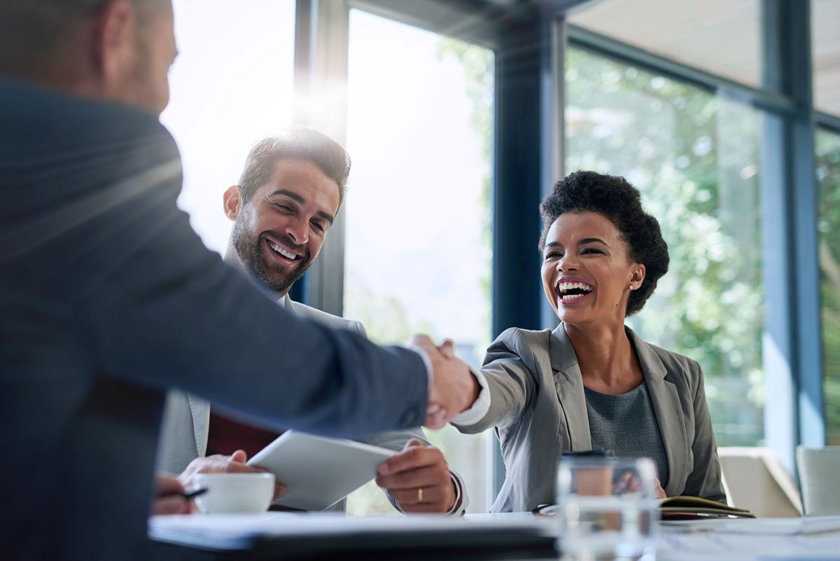 business partnership shaking hands trust smiling